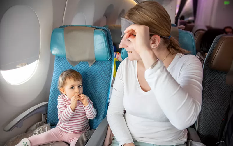 parents stressed out over kids in a plane, family travels, January 2025, UK